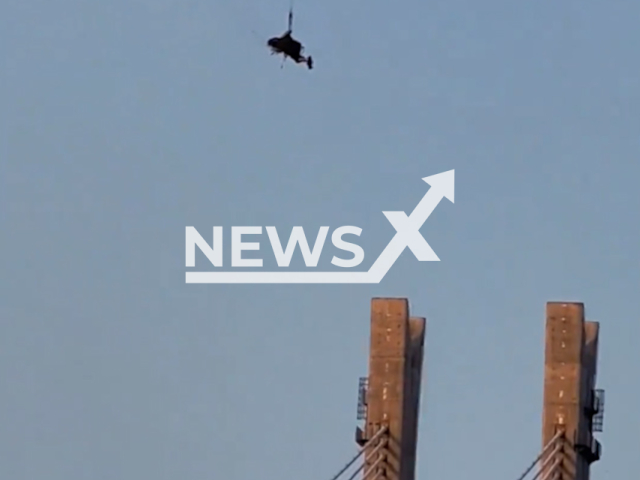 A paraglider is caught hanging on a crane by his parachute, on Friday, June 19, 2026,  in Nanchong City, China. He was rescued. Note: Photo is a screenshot from a video. (AsiaWire/NX)