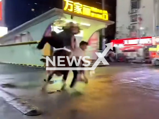 A loose bull attacks people on the street, on Sunday, June 21, 2026, in Changsha, China.  It injured three people. Note: Photo is a screenshot from a video. (AsiaWire/NX)