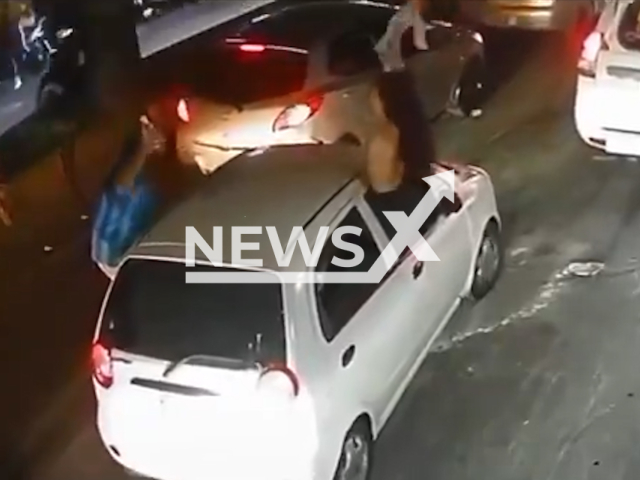 A woman celebrating Colombia's win in the World Cup removes her bra while hanging out of the passenger s window of a car, in Armenia, Colombia. Note: Photo is a screenshot from a video. (Newsflash/NX)