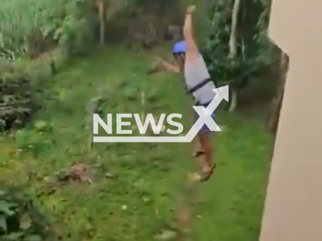 A man falls from a zipline at a resort in Dandeli, India. The safety lock allegedly snapped, causing him to plunge to the ground from a height of around 40 feet. Note: Photo is a screenshot from a video. (Newsflash/NX)
