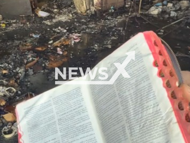 Picture show the Bible at the scene of the fire. It remained intact after a fire destroyed a packaging store in Jardim Balneario Meia Ponte, Brazil. Note: Picture is a screenshot from video. (Harrisons)