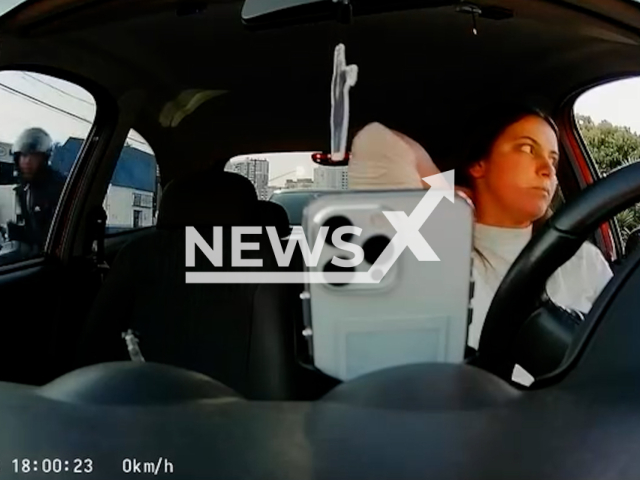 A ride share driver is robed driving in the middle of busy avenue, in Sao Paulo, Brazil. A recently purchased cell phone was stolen. Note: Photo is a screenshot from a video. (@talenkphotos, Newsflash/NX)