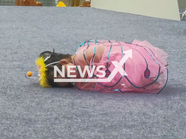 Cute little girl fell asleep on stage during performance in Chongqing, China. Note: Picture is a screenshot from a video (1627441767/AsiaWire)