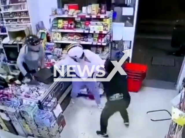 The owner of a shop faces two robbers to avoid a robbery at gunpoint, Malaga , Spain, on 6th June. Note: Picture is a screenshot from a video (Newsflash)