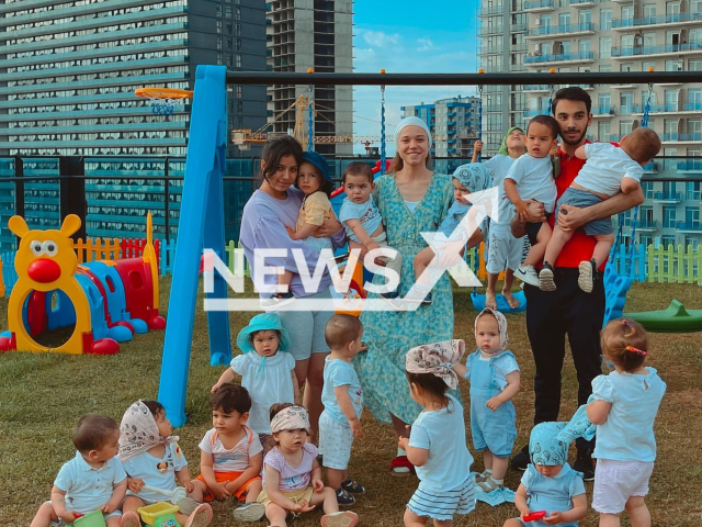 Cristina Ozturk, (middle)  pictured, with children and friends, who has 22 children through surrogate mothers, said, 'I am having a hard time',  because her husband Galip Ozturk,  was detained in Batumi, Georgia in May, 2022.
 
Note: Private photo.  (@batumi_mama/Newsflash)