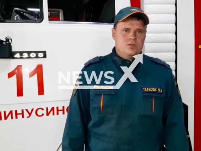 The commander of a separate post of the fire and rescue unit No. 11 of the Russian Emergencies Ministry, Maxim Tarasyuk assisted the 15-year-old girl who was dragged into the culvert of a dam in the Minusinsk district of the Krasnoyarsk Territory in Russia on 27th June 2022. Note: Picture is a screenshot from a video (@mchskrsk/Newsflash)