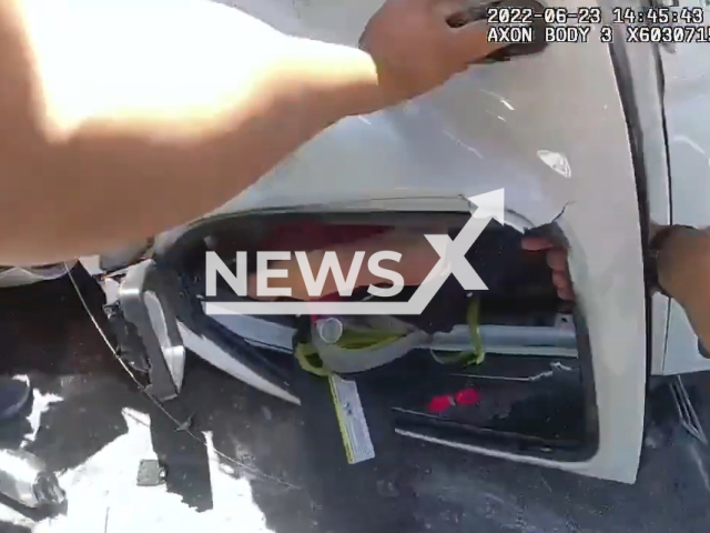 West Patrol Officer's bodycam showing the rescue of a woman from a burning vehicle, on the 23th of June, in San Antonio, Texas. Note: Picture is a screenshot from a video (San Antonio Police Department/Newsflash)