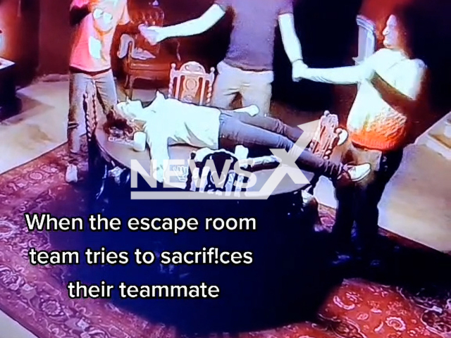 Escape room team tries to sacrifice their teammate to win the game, in April, 2022 in Copenhagen, Denmark.
Note: This picture is a screenshot from the video.
(@mysterymakers/Newsflash)