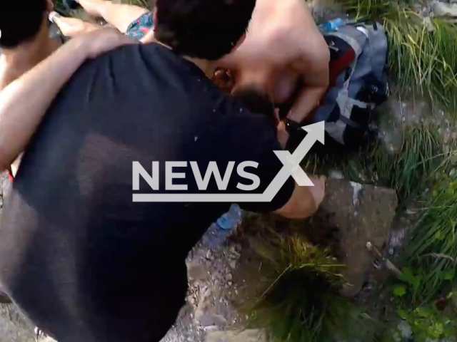 Moment of the rescue of a woman who fell into the river Dobra, in the municipality of Cangas de Onis, Spain, July 2022. Note: Picture is a screenshot from a video (SEPA/Newsflash)