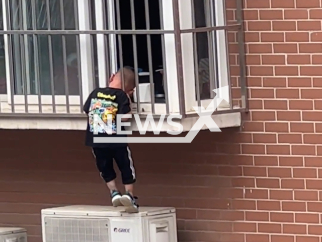 Boy is stuck with his head in anti theft window railings in Baoding, China. Note: Picture is a screenshot from a video (76939052/AsiaWire)