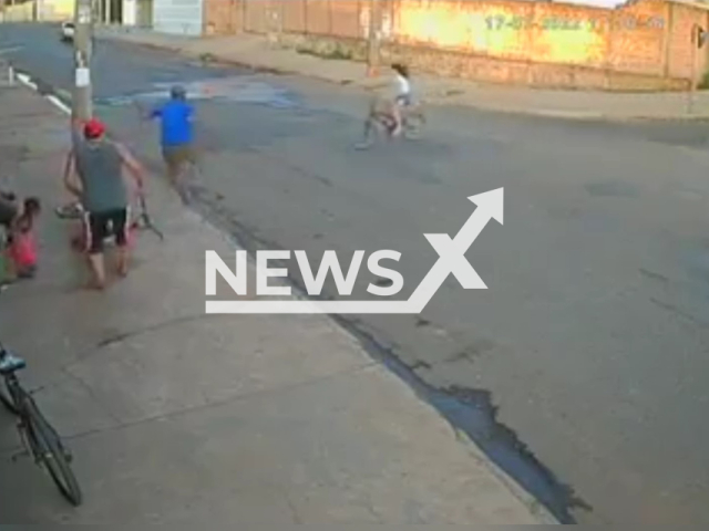 Woodworker, 26, saves a girl from hitting a pole with her bicycle, in Americo Brasiliense, Brazil, on July, 17, 2022.  The girl is seen speeding down a hill before entering into the road and heading straight for the utility pole on the pavement.
Note: Photo is a screenshot from the video (Newsflash)