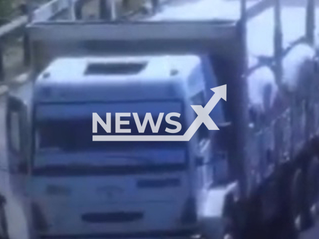 A vehicle collides with another vehicle from behind in Adana, Turkey, in undated footage. Vedat Yilmaz, who was kneeling in front of the vehicle to search for the source of the malfunction in his vehicle, miraculously escaped the accident without injury. Note: Picture is a screenshot from a video (Newsflash)