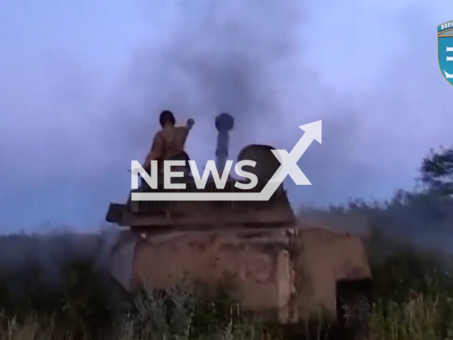 Soldier of the 35th separate marine infantry brigade named after Rear Admiral Mykhailo Ostrogradskyi stands on a tank in undated footage. The brigade works against Russian enemies in the Kherson direction, Ukraine.  Note: This picture is a screenshot from the video (@35obrmp/Newsflash)