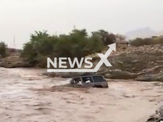 Omani people drive into a flooded valley in the Wadi Bani Ghafer area in the Wilayat of Rustaq town in Oman. They were later arrested by the Omani police. Note: Picture is a screenshot from a video (@RoyalOmanPolice/Newsflash)