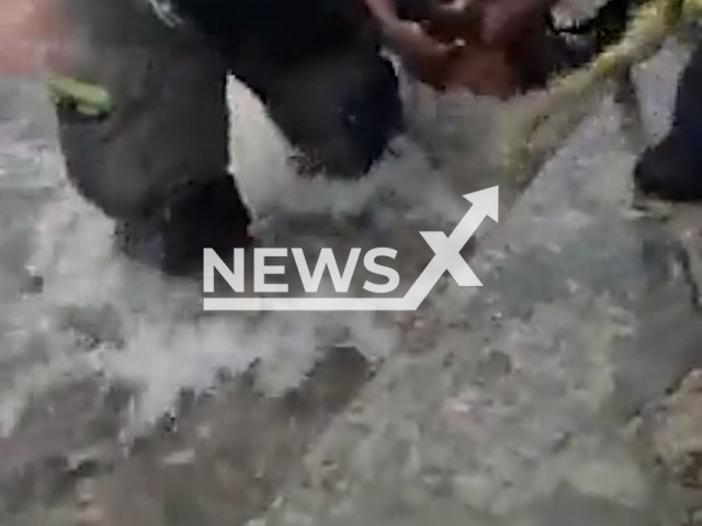 Photo shows emergency crews and the rescued man in Hermosillo, Mexico, on Thursday, July 28, 2022, in a screen from a video. The man was trapped under a bridge due to heavy rains. Note: This picture is a screenshot from the video (@SonoraSeguridad/Newsflash).