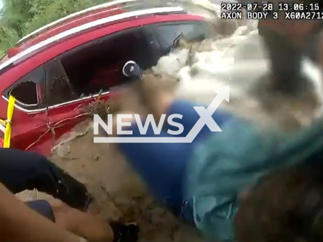 Rescue of a motorist stranded in their car during a flood, on Thursday, July 28, 2022, in Apache Junction, Arizona, USA. They were unable to retrieve her dog from the water. Note: Picture is a screenshot from a video (@ApacheJunctionPD/Newsflash)