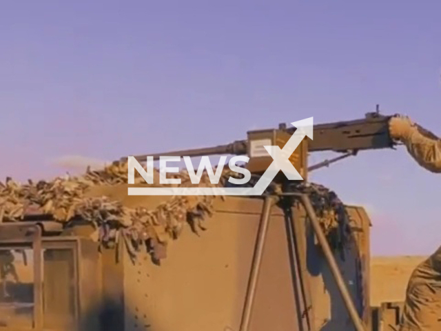 Soldier of the 59th separate motorized infantry brigade named after Yakov Handziuk stands on a tank and aims a machine gun in Ukraine in an undated photo. The brigade is subordinated to the operational command South. Note: Picture is a screenshot from a video (@59ompbr.com.ua/Newsflash)