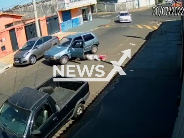 A man falls from his own moving car in Franca, Brazil, Saturday, July 30, 2022. After going over a speed bump, the vehicle door opened and the driver fell to the asphalt.  Note: This picture is a screenshot from the video (Newsflash).