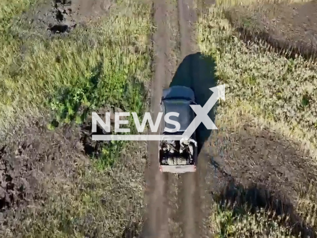 Car with fighters of the 93rd brigade goes down the road in a field area in Ukraine in an undated photo. Soldiers of the 93rd brigade Kholodny Yar shelled Russian tank with Z letter on it and made Russian trooper run away from his damaged tank. Note: Picture is a screenshot from a video (@UkrainianLandForces/Newsflash)