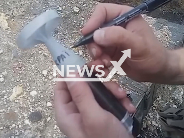 Ukrainian border guard writes ''For Ukraine" on the bomb before it was dropped by drone on Russian military positions in Ukraine in undated footage.
The border guards thank the volunteers who gifted them the drones.
Note: Picture is a screenshot from a video (State Border Service of Ukraine/Newsflash)