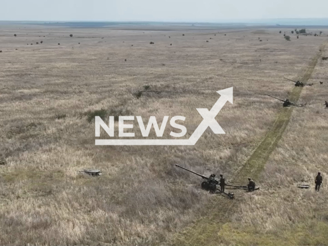 Soldiers of the 11th Brigade named after Mykhailo Hrushevsky of the National Guard of Ukraine, unit 3012 stand near three howitzers in a field area of in the south of Ukraine in an undated photo. Odesa Guardsmen perform service and combat tasks both inside the country and on the front line - decently protecting the south of Ukraine. Note: Picture is a screenshot from a video (@3012NGU/Newsflash)