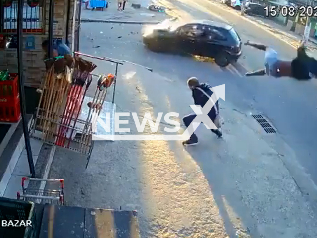 An unknown man goes flying from a motorcycle after collision with car, as a man walking on the side walks narrowly avoids the flying man, in Rio de Janeiro, Brazil, on Monday, Aug. 15, 2022. The injured man was taken to the to hospital. Note: Picture is a screenshot from a video (Newsflash)