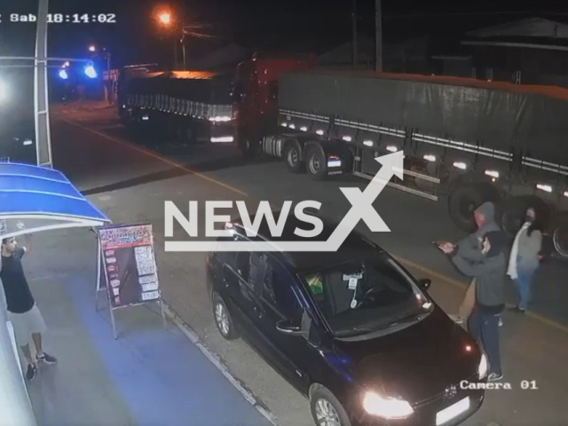 A man points a gun at an unidentified man,  in Campo Largo, Brazil, on Saturday, Aug. 13, 2022.  Three individuals were attempting to steal the car. Note: Picture is a screenshot from a video (Newsflash)