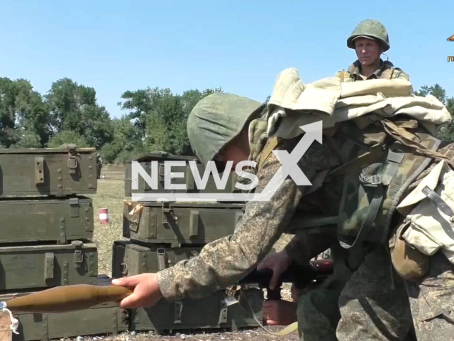 DPR soldier holds rocket launcher near boxes with ammunition at the training grounds of the DPR in an undated footage. Combat training, coordination of units and practical development of the acquired knowledge in the conditions of imitation of urban battles takes place in order to increase the efficiency of the DPR military units. Note: This picture is a screenshot from the video (@nm_dnr/Newsflash).