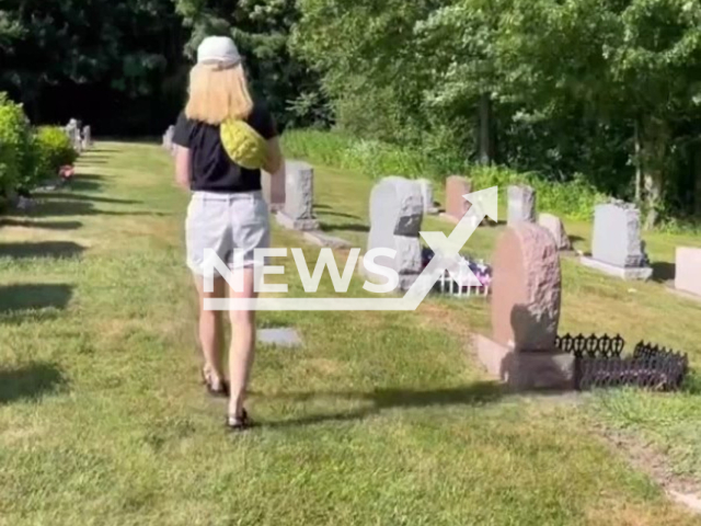 Rosemary Grant, 32, from Washington DC, looks for recipes inscribed on tombstones, in undated footage. Ms. Grant's current favorite recipe is the spritz cookies, found on the grave of Naomi Miller Dawson. Note: Photo is a screenshot from the video (@ghostlyarchive/Newsflash)