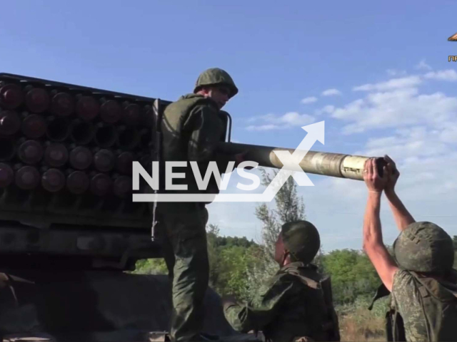 Three artillerymen of the 1st Slavic Brigade of so-called DPR loads rockets into launcher in the Avdiivka direction, Donetsk region, Ukraine in an undated footage. DPR soldiers used BM-21 Grad self-propelled 122 mm multiple rocket launcher against Ukrainian army. Note: Photo is a screenshot from the video (@nm_dnr/Newsflash)