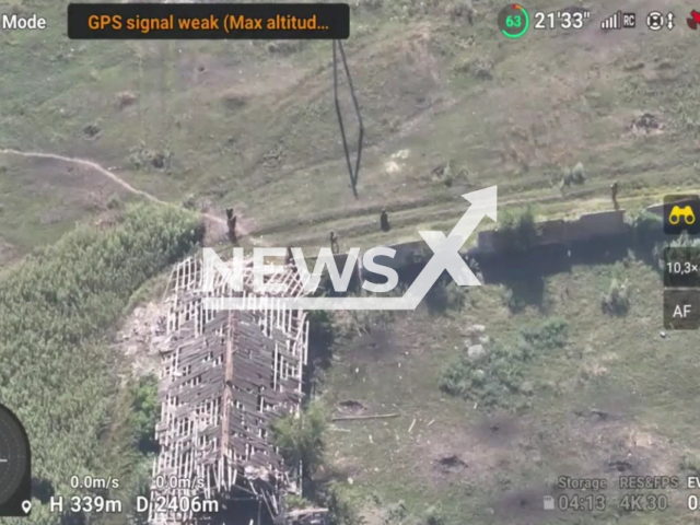 Russian soldiers go close to building in a field area in the Donetsk direction of Ukraine, Saturday, Aug. 20, 2022. Military units of the Navy of Ukraine destroyed two tanks, BMP, a vehicle with enemy ammunition, 12 Russian invaders were killed and wounded, and one Giatsint-S self-propelled howitzer was destroyed. Note: Photo is a screenshot from the video (@503obmp/Newsflash)