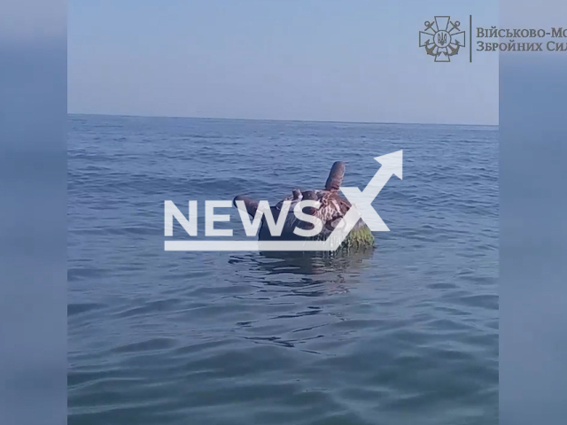 An anti-ship mine drifts near the sea shore of Odesa, Ukraine, Sunday, Aug. 21, 2022. The explosive projectile was successfully destroyed by a special unit of the Navy of the Armed Forces of Ukraine. Note: This picture is a screenshot from the video (@navy.mil.gov.ua/Newsflash).