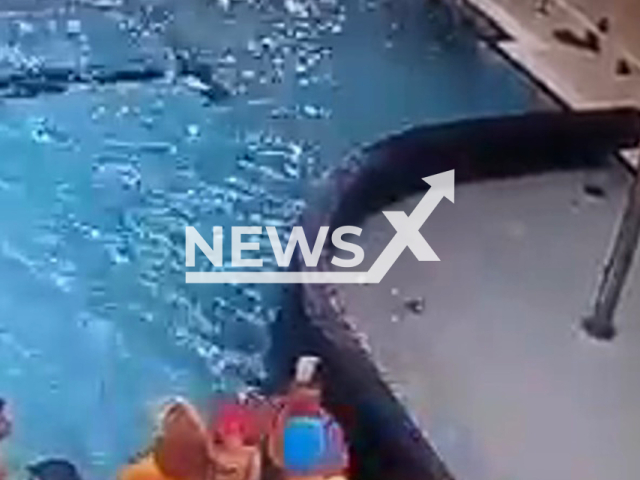 A lifeguard saves a child drowning in Sosnowiec, Poland, undated. The child is right next to the woman who does not notice the child's distress. Note: Picture is a screenshot from a video (Newsflash)