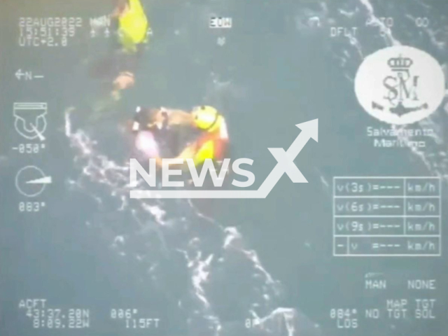 Rescuer reaches the girl at sea in Valdovino, Spain, Monday, Aug. 22, 2022. She was dragged by a sea current while paddle surfing. Note: This picture is a screenshot from the video (@salvamentogob/Newsflash).