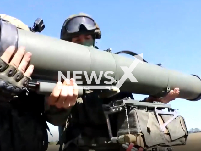 Two Russian soldiers set Kornet anti-tank missile system on its rack  in Ukraine in undated footage. Kornet is designed to destroy modern and advanced tanks equipped with dynamic protection, fortifications, extended unarmored and lightly armored targets, hovering helicopters. Note: Picture is a screenshot from a video (@mil/Newsflash)