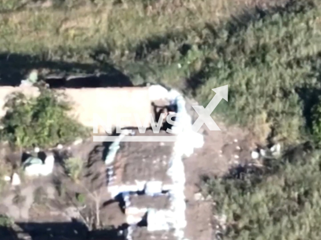 Russian soldier stands in dugout in a forest area in the north of Kharkiv region, Ukraine in undated footage. Fighters of National Guard of Ukraine destroyed observation post of Russian occupiers with help of unmanned aerial vehicle (UAV). Note: Picture is a screenshot from a video (@ngu.east/Newsflash)