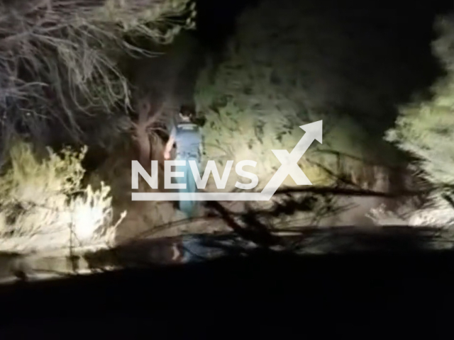 Picture shows a police officer during the rescue, undated. Police rescued three girls, lost in an area with difficult terrain and the dense vegetation in Donana National Park, Spain. Note: Picture is a screenshot from a video (Newsflash)