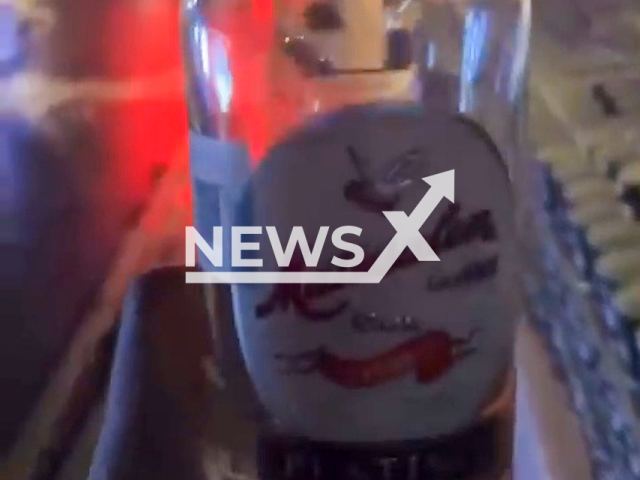 Picture shows the bottle of alcohol used to spike the drinks. A man poured rum into the cups of the marathon runners, in Mexico City, Mexico, on Sunday, Aug. 28, 2022. Note: Picture is a screenshot from a video (Newsflash)