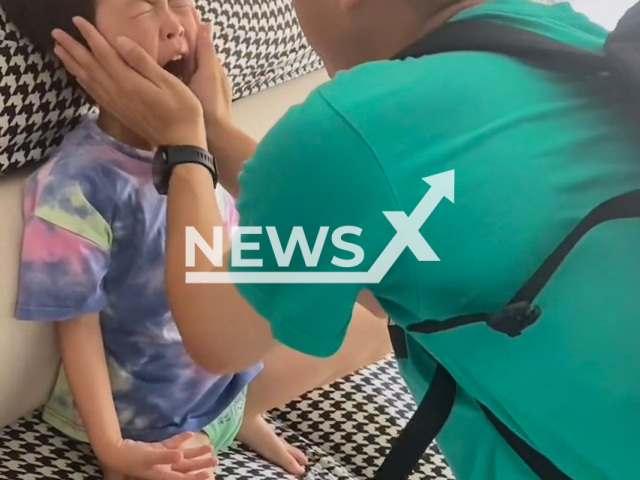 A boy cries and refuses to say goodbye to his dad who was recalled to the army in Qingdao city, Shandong province, China, in a screenshot of undated footage. The mother said the child was having a fever and wanted his dad to stay with him. Note: Picture is a screenshot form a video (xiaotanke89/AsiaWire)