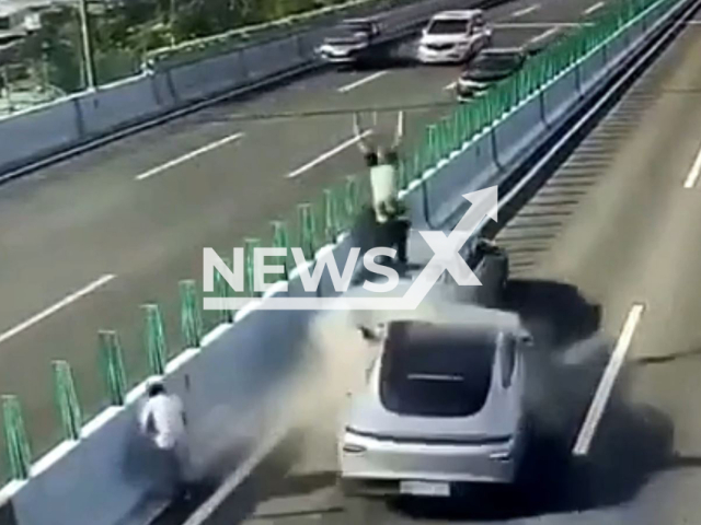 Car crashes into faulty vehicle and hits a man in Ningbo, Zhejiang province in China, in undated footage. The driver claimed that the driving assistance mode was on but failed to detect the man and the vehicle - which led to the collision. Note: This picture is a screenshot from the video (AsiaWire).