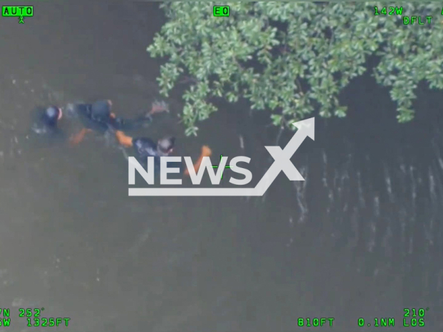 The officer jumps in the water and arrests the suspect in Atlanta, Georgia, the USA on 25 August 2022. Note: Photo is a screenshot from the video (@Atlanta_Police/Newsflash)