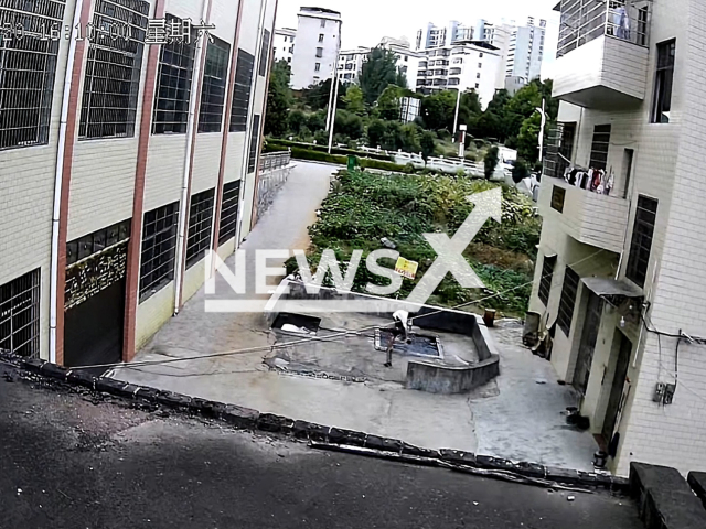 A young man rescues a child from drowning in a water pool in Chenzhou city, Hunan province, China, on Saturday, Aug. 20, 2022. The boy fell into the water while playing next to the pool. Note: This picture is a screenshot from the video (@hbh1881/AsiaWire).