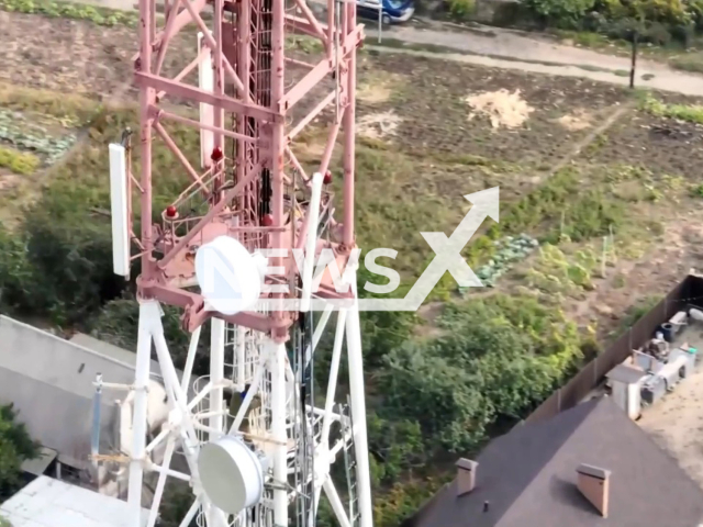 Ukrainian soldier of the 92nd separate mechanized brigade named after Ivan Sirko  climbs up broadcast tower in Kupiansk, Kharkiv region, Ukraine in undated photo. As a result of a successful counteroffensive by units of the Armed Forces in the Kharkiv direction, Russian troops abandoned their positions. Note: Picture is a screenshot from a video (@92OMBr/Newsflash)