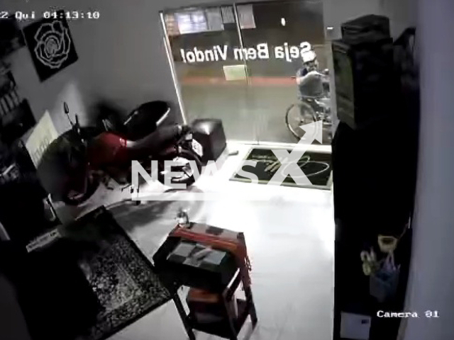 A man in a wheelchair breaking the door to a  store in Campo Grande, Brazil, on Thursday, Sept. 8, 2022. He stole a cell phone and other accessories and has not yet been located. Note: Picture is a screenshot from a video (Newsflash)