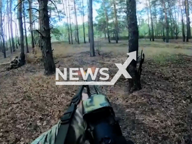 Ukrainian soldier shoots a gun in a forest area in Ukraine in undated photo. Fighters of the Special Operations Forces of the Armed Forces of Ukraine (SSO) noticed the movement of the Russian enemy car during reconnaissance and started to shoot at it.  Note: This picture is a screenshot from the video (@usofcom/Newsflash).