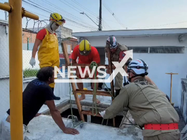 Firefighters work to remove the body of a five-year-old boy from a sewer, in Manaus, Brazil, on Saturday, Sept. 10, 2022. Levy William Nascimento  died after falling into a sewer while playing.   Note: Picture is a screenshot from a video (@orleilsoximenes.muniz/Newsflash)