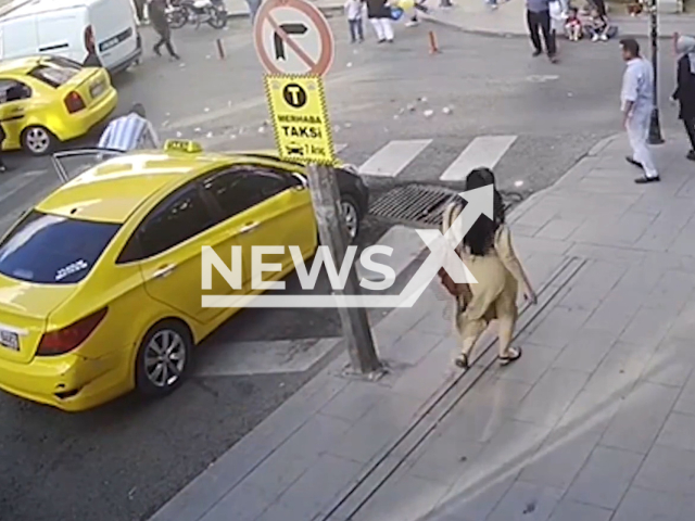 People collect money scattered around due to wind in Kirikkale, Turkey, Wednesday, Sept. 7, 2022. The money was then handed over to its owner. Note: Picture is a screenshot from a video (Newsflash)