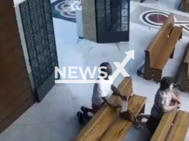 A man stealing the handbag of a woman praying in a church in Colatina, Brazil, on Monday, Sept, 12, 2022. The man was arrested and confessed to the theft and where the woman's cell phone and bag were. Note: Photo is a screenshot from a video. (Newsflash)