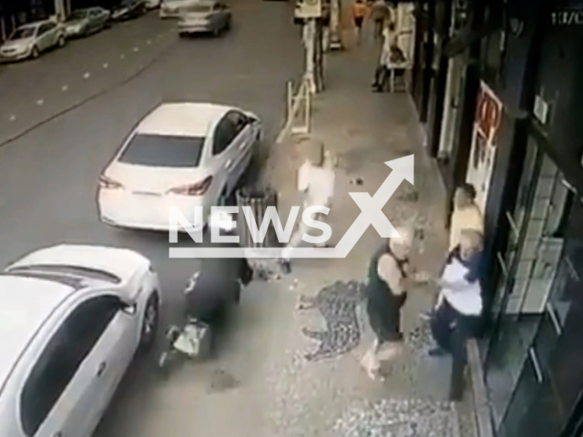 A pedestrian narrowly escapes being hit by an out of control motorcycle in Tupa, Brazil, on Tuesday, Sept. 13, 2022. The motorcycle  was stolen, and hit a parked car but no pedestrians. Note: Picture Is Screenshot From Video(Newsflash).