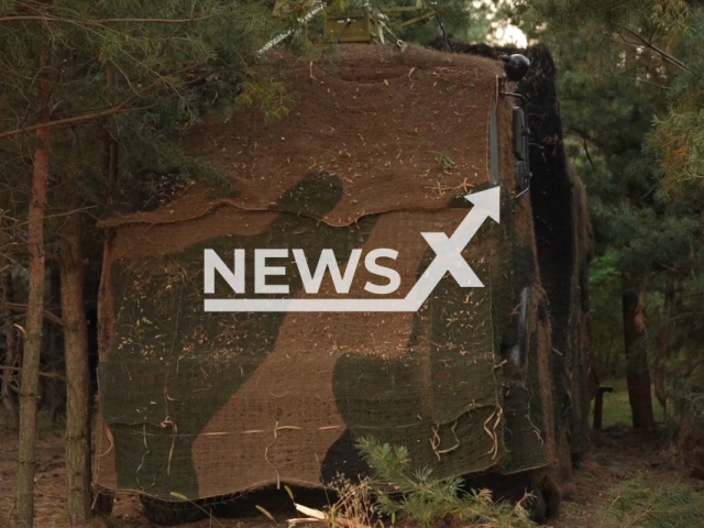 The Iskander operational-tactical missile system stands under camouflage net under trees in Ukraine in undated photo. Russian crews of the Iskander operational-tactical missile systems of the Western Military District shot at Ukrainian military infrastructure at night. Note: Picture is a screenshot from a video (@mil/Newsflash)